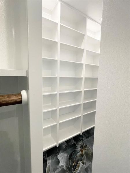 Master closet contains amazing shoe storage shelves.