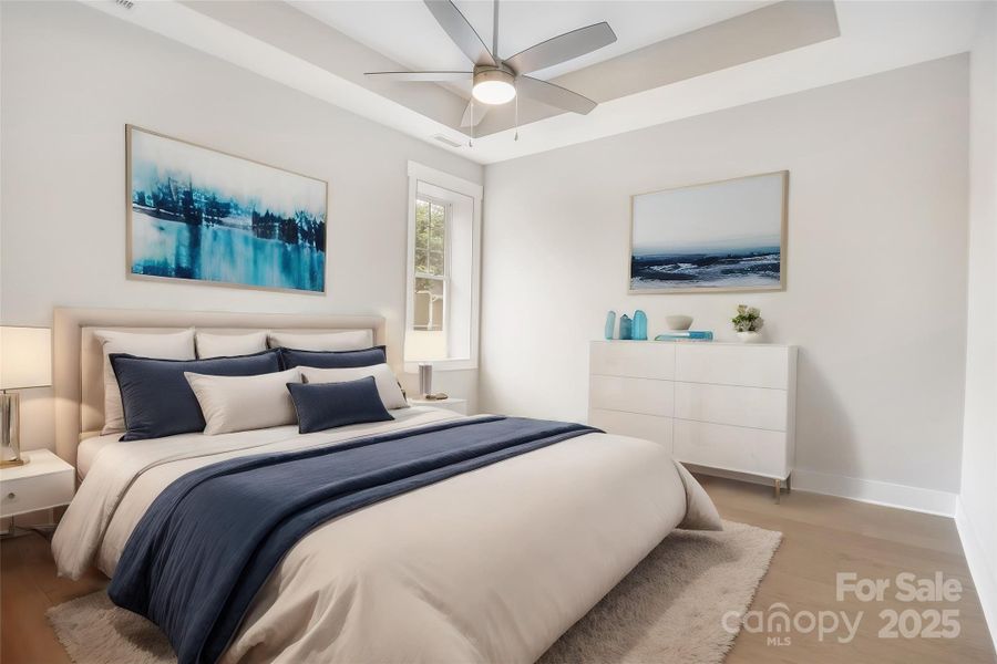 Virtually staged primary bedroom with trey ceiling and ceiling fan.
