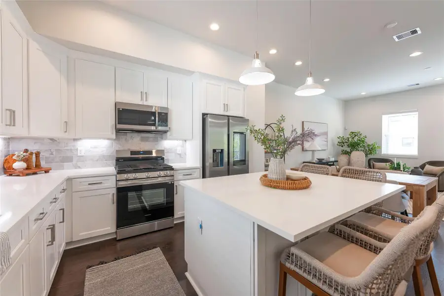 Modern kitchen with sleek cabinetry, stainless steel appliances, and a spacious island perfect for entertaining. Modern kitchen with sleek cabinetry, stainless steel appliances, and a spacious island perfect for entertaining.