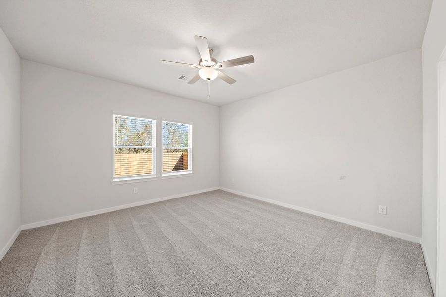 A room with a ceiling fan and a window. A room with a ceiling fan and a window.