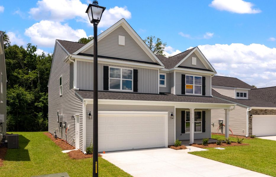 Front exterior of a new home in Oakley Pointe, Moncks Corner, SC, highlighting curb appeal (Image 20).