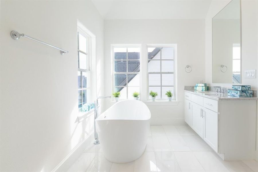 Primary bath with high ceilings and furniture grade cabinets.  (similar home and features)