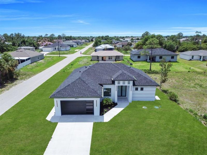 Front exterior of a new home in , Lehigh Acres, FL, highlighting curb appeal (Image 20).