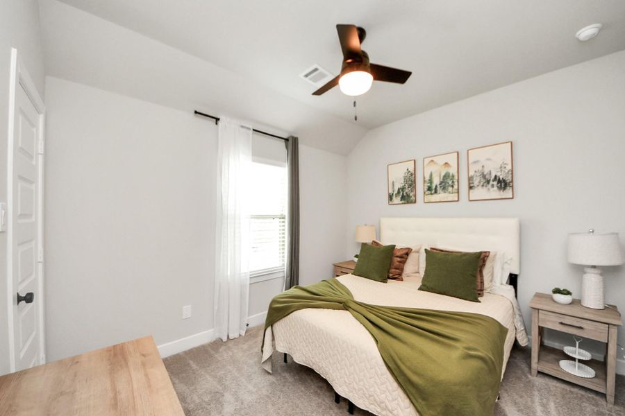4th bedroom with ceiling fan, soft carpet, and a large with that allows tons of natural lighting in.