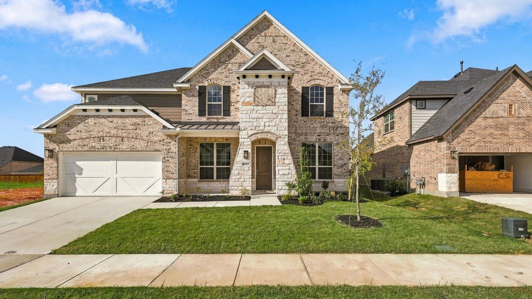 Front exterior of a new home in Green Meadows Classic, Celina, TX, highlighting curb appeal (Image 22).