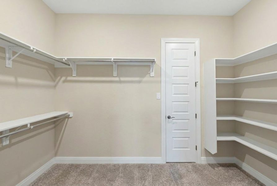 Ample shelving and hanging space defines this highly functional walk-in closet. Ample shelving and hanging space defines this highly functional walk-in closet.