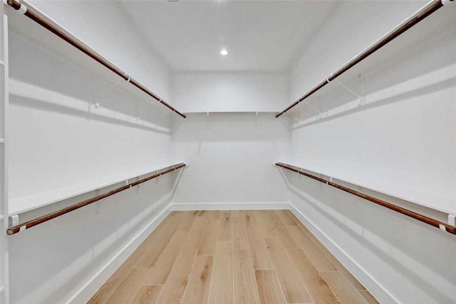 Giant walk in closet with plenty of storage located in primary bathroom.