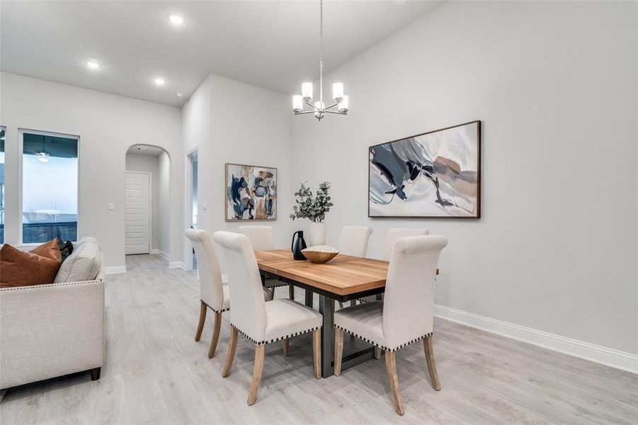 Dining room featuring light hardwood / wood-style floors and a notable chandelier