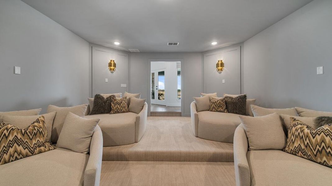 The back staircase leads up to a spacious game room and media room. Representative image. The back staircase leads up to a spacious game room and media room. Representative image.