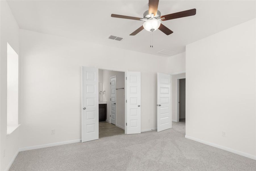 Unfurnished bedroom with light carpet, baseboards, ceiling fan, and visible vents