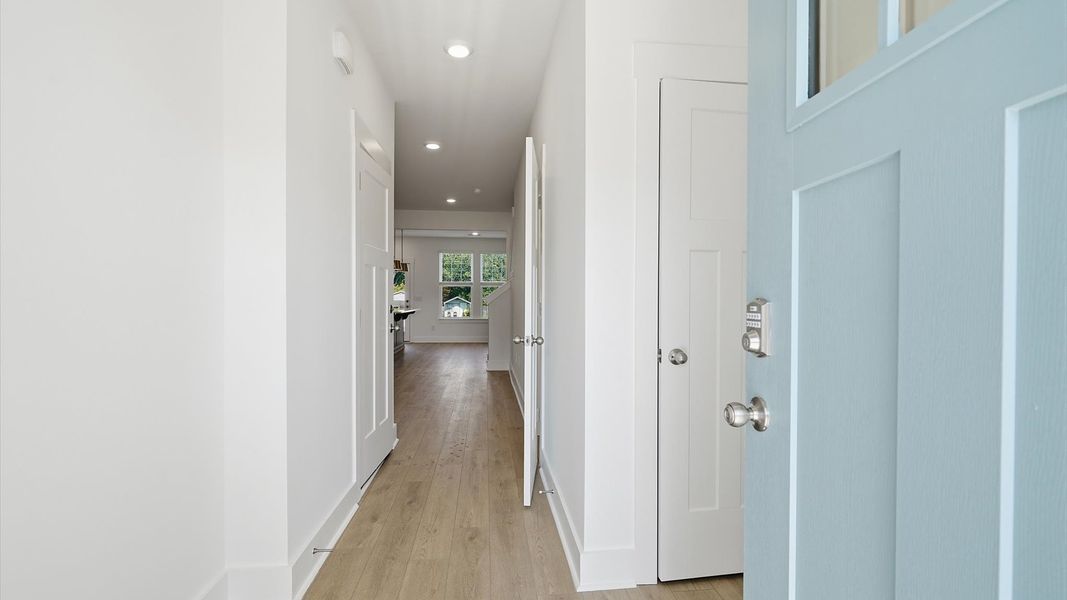 Memorable arrival experience with hardwood floors and elegant trim in the foyer