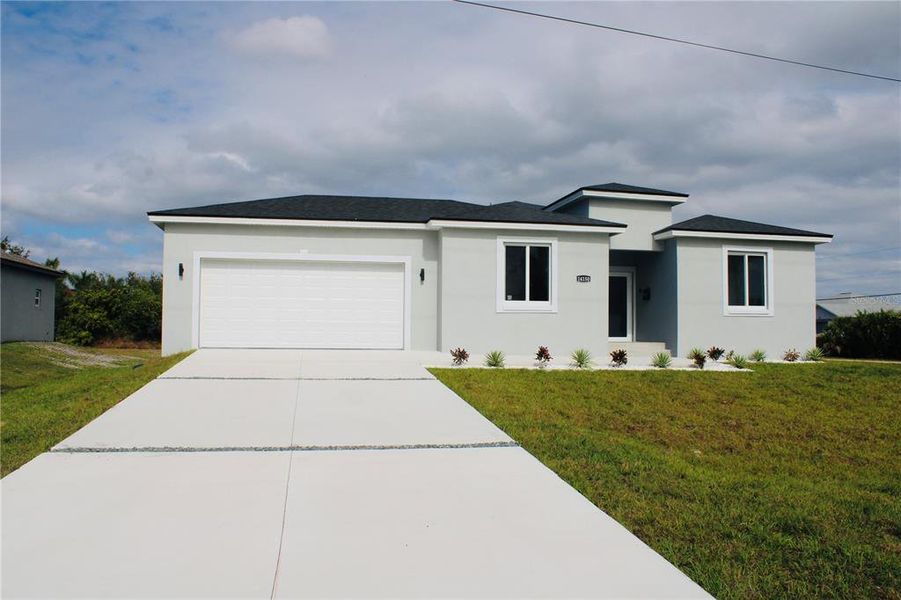 Front exterior of a new home in , Port Charlotte, FL, highlighting curb appeal (Image 24).
