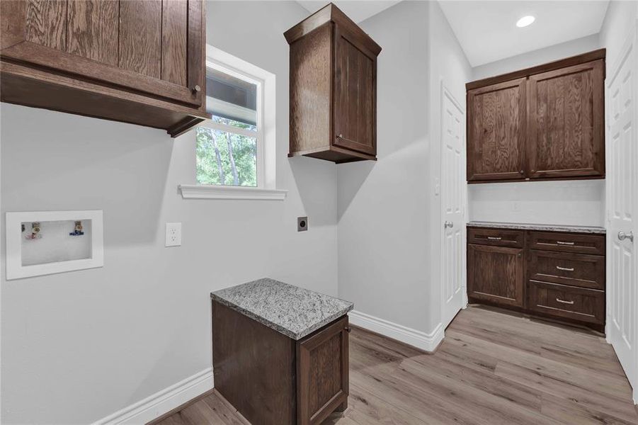 Utility room off kitchen has pantry and a coffee bar.