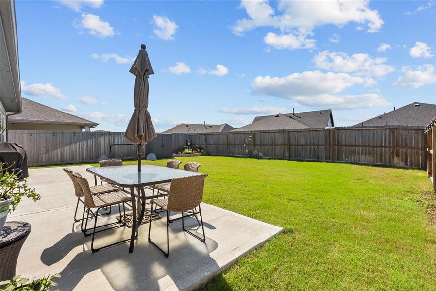 Enjoy the covered back patio overlooking the nice-sized backyard with plenty of space to relax, play, or entertain.
