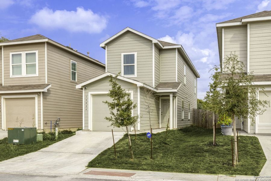 Front exterior of a new home in Presa Point, San Antonio, TX, highlighting curb appeal (Image 1).