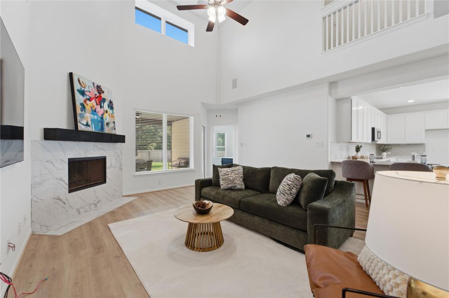 A striking fireplace, with soaring ceilings, anchors this spacious living area. A striking fireplace, with soaring ceilings, anchors this spacious living area.