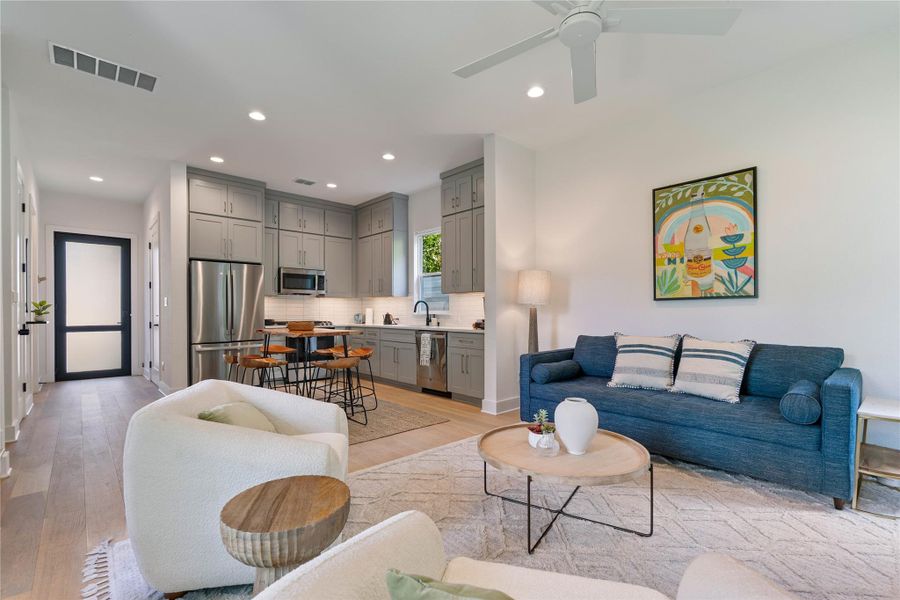 An open floor plan connects the comfortable living area directly to a contemporary kitchen.