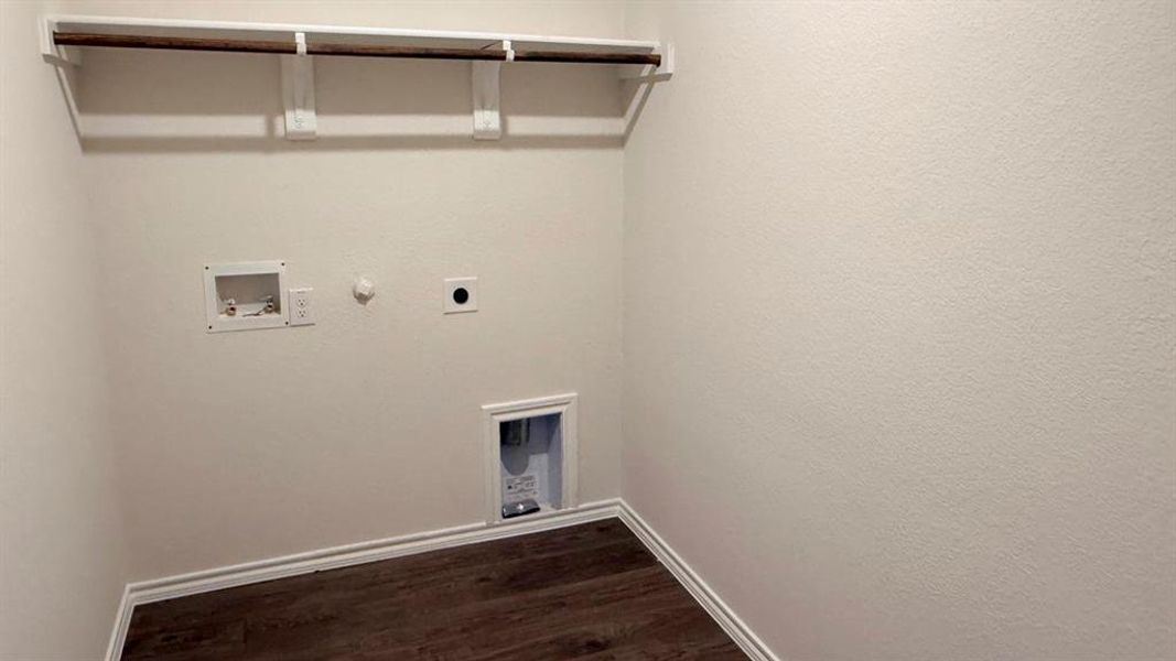 Washroom featuring hookup for a gas dryer, dark wood finished floors, hookup for a washing machine, and hookup for an electric dryer Washroom featuring hookup for a gas dryer, dark wood finished floors, hookup for a washing machine, and hookup for an electric dryer