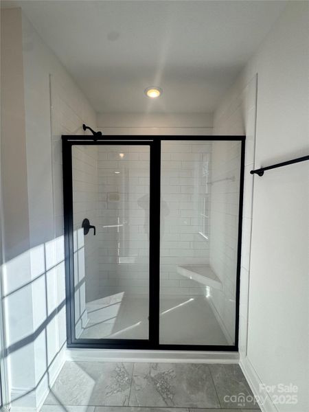 Ceramic tile shower in primary bathroom