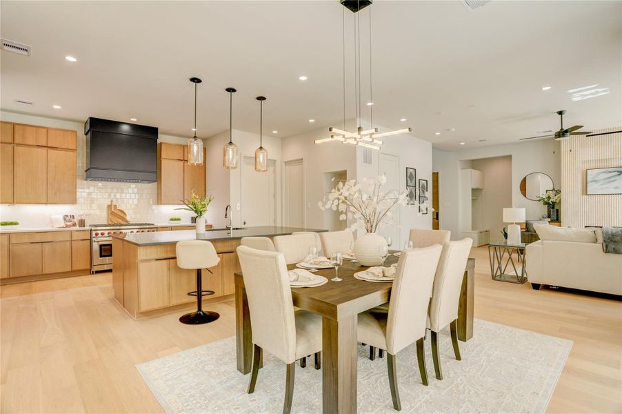 View of the dining room and island kitchen from the sliding glass patio doors.