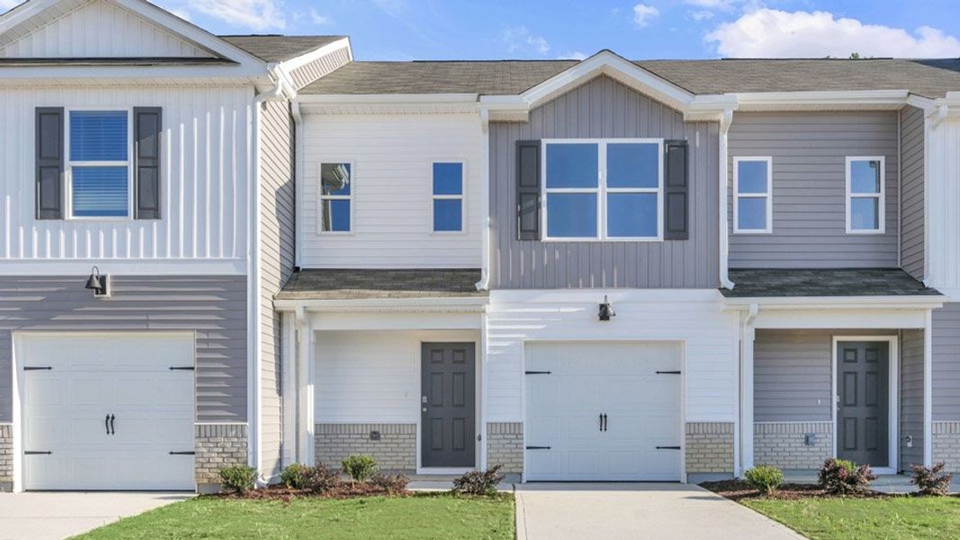 Front exterior of a new home in The Townes at Honeycutt Oaks, Angier, NC, highlighting curb appeal (Image 1). Front exterior of a new home in The Townes at Honeycutt Oaks, Angier, NC, highlighting curb appeal (Image 1).