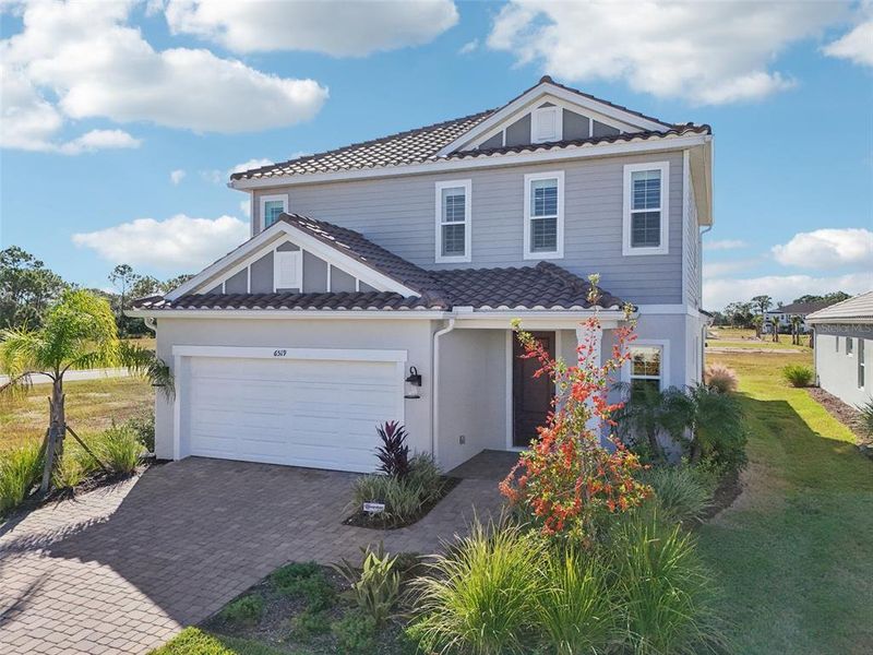 Front exterior of a new home in , Sarasota, FL, highlighting curb appeal (Image 26). Front exterior of a new home in , Sarasota, FL, highlighting curb appeal (Image 26).