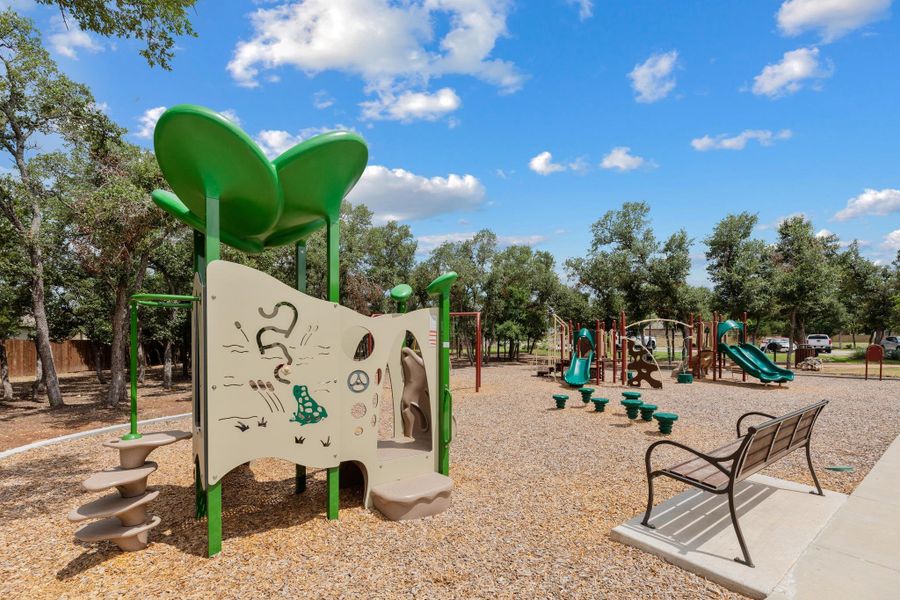 A well-equipped community playground offers ample space for recreation, surrounded by mature trees. A well-equipped community playground offers ample space for recreation, surrounded by mature trees.