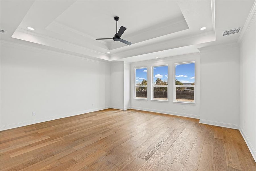 Spare room featuring a ceiling fan, ornamental molding, light wood finished floors, and recessed lighting