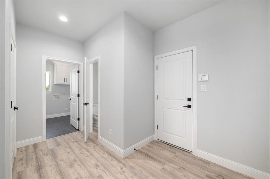 Entrance foyer featuring light wood-style flooring, baseboards, and recessed lighting
