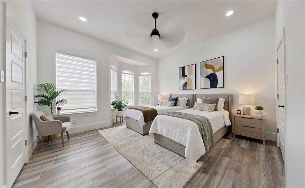 Spacious room featuring wood-finish flooring, recessed lighting, and a contemporary ceiling fan Spacious room featuring wood-finish flooring, recessed lighting, and a contemporary ceiling fan