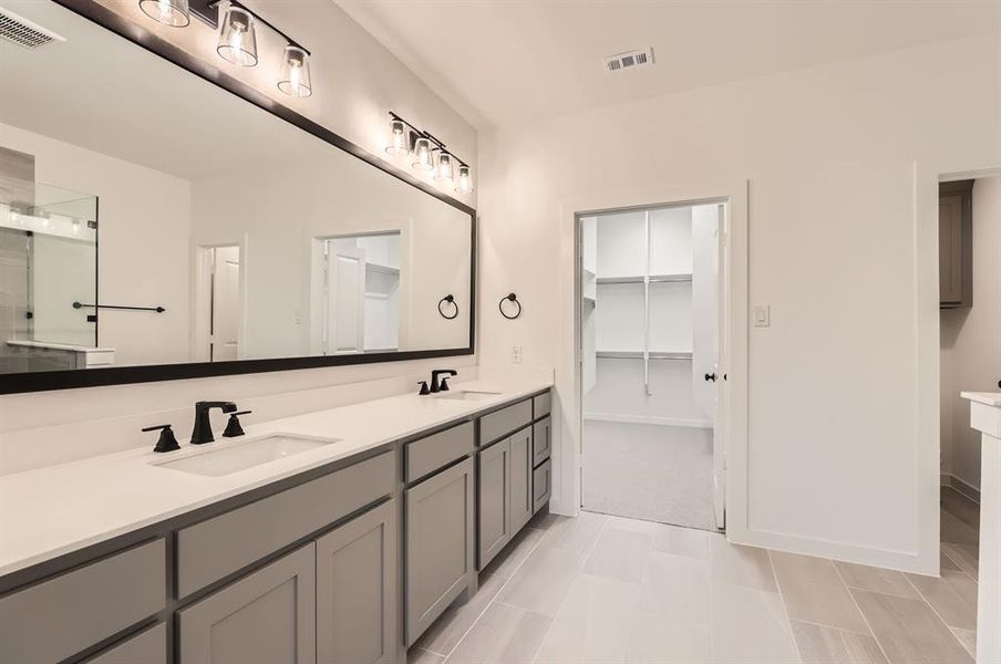 Bathroom featuring tile patterned flooring and vanity