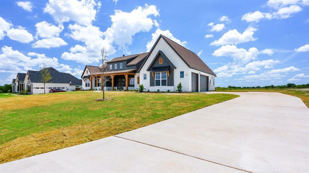 View of front of home featuring a front lawn and a garage