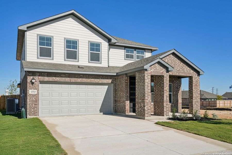 Front exterior of a new home in Carmel Ranch, Schertz, TX, highlighting curb appeal (Image 2). Front exterior of a new home in Carmel Ranch, Schertz, TX, highlighting curb appeal (Image 2).