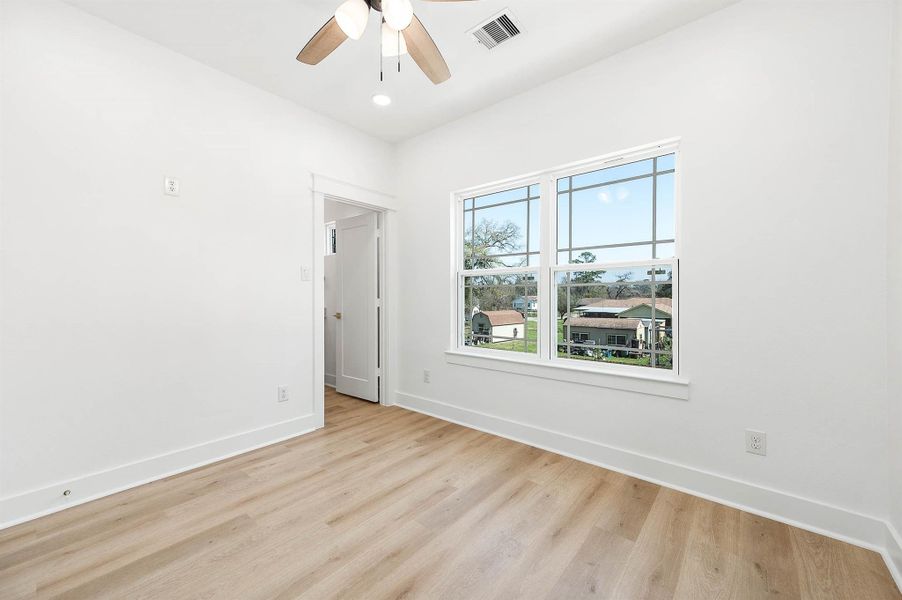 Third bedroom with large windows, clean finishes, and a neutral palette perfect for guests, a home office, or a growing household.