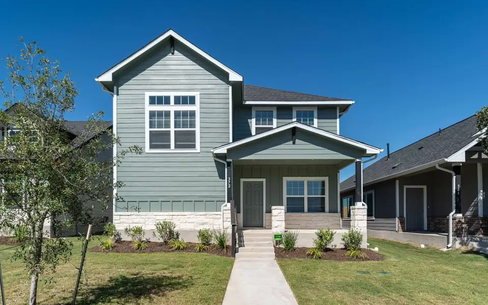 Front exterior of a new home in Paramount, Kyle, TX, highlighting curb appeal (Image 1). Front exterior of a new home in Paramount, Kyle, TX, highlighting curb appeal (Image 1).