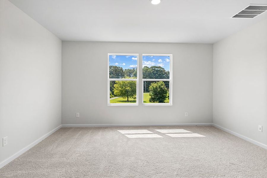 A room with a window and a rug in it.