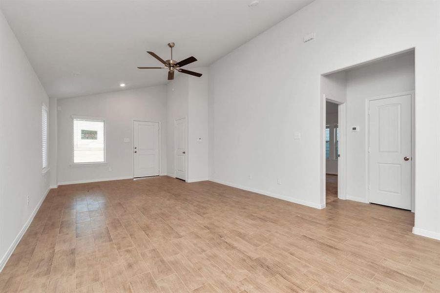 The spacious living area offers a canvas for your personal style. With its neutral tones and large windows, this room is filled with natural light, creating a warm and inviting atmosphere. Whether you're hosting guests or enjoying a quiet evening, this space adapts to all your needs. **This image is from another Saratoga Home - Clover floorplan.**