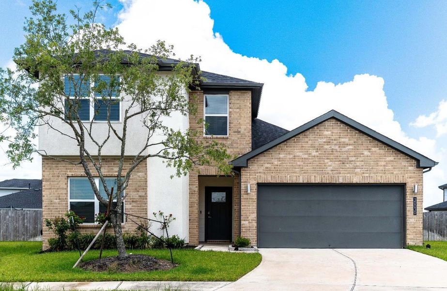 Front exterior of a new home in Tamarron, Katy, TX, highlighting curb appeal (Image 1).
