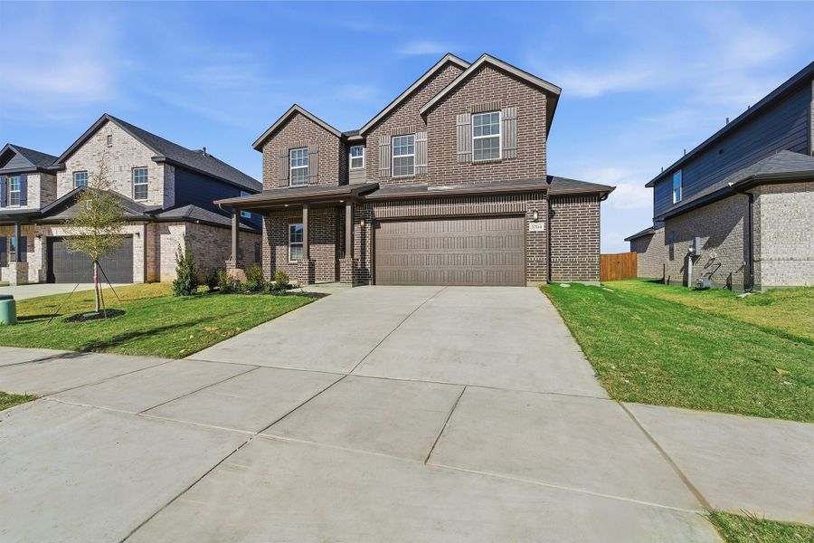 Front exterior of a new home in Sagebrook, Argyle, TX, highlighting curb appeal (Image 2). Front exterior of a new home in Sagebrook, Argyle, TX, highlighting curb appeal (Image 2).