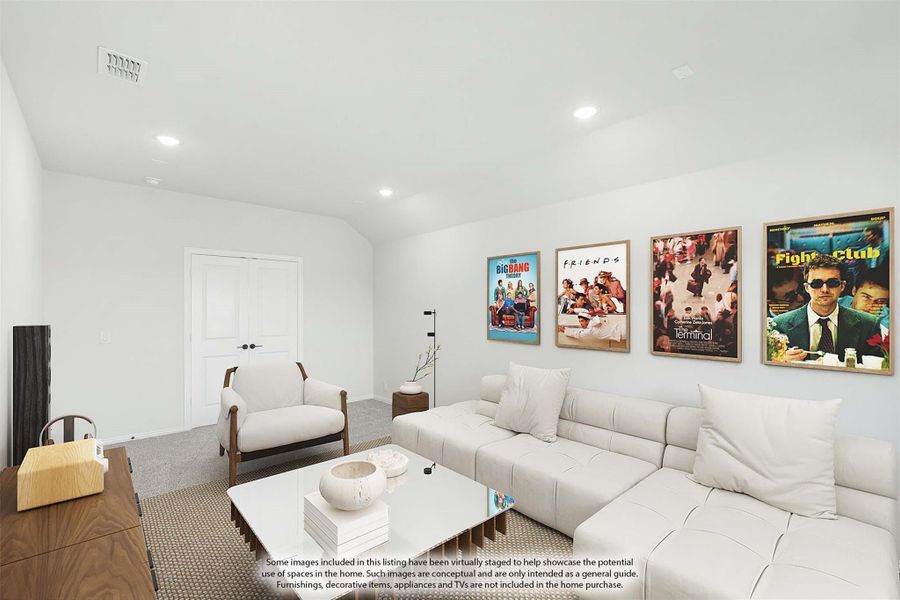 Living room with white sectional sofa, framed movie posters on wall, and vaulted ceiling with recessed lighting Living room with white sectional sofa, framed movie posters on wall, and vaulted ceiling with recessed lighting