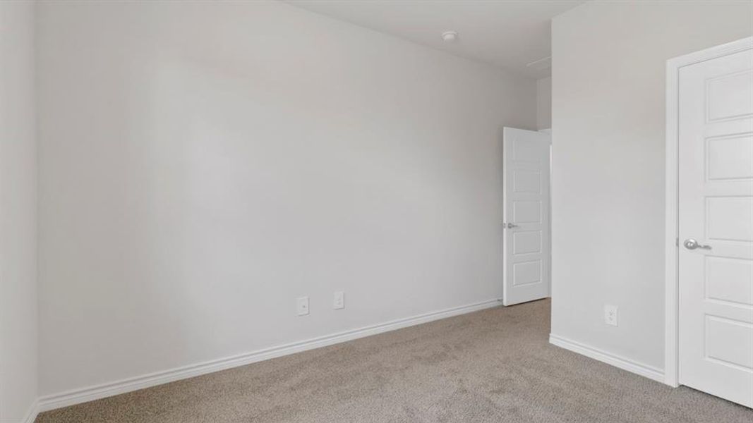 Unfurnished bedroom with carpet and baseboards