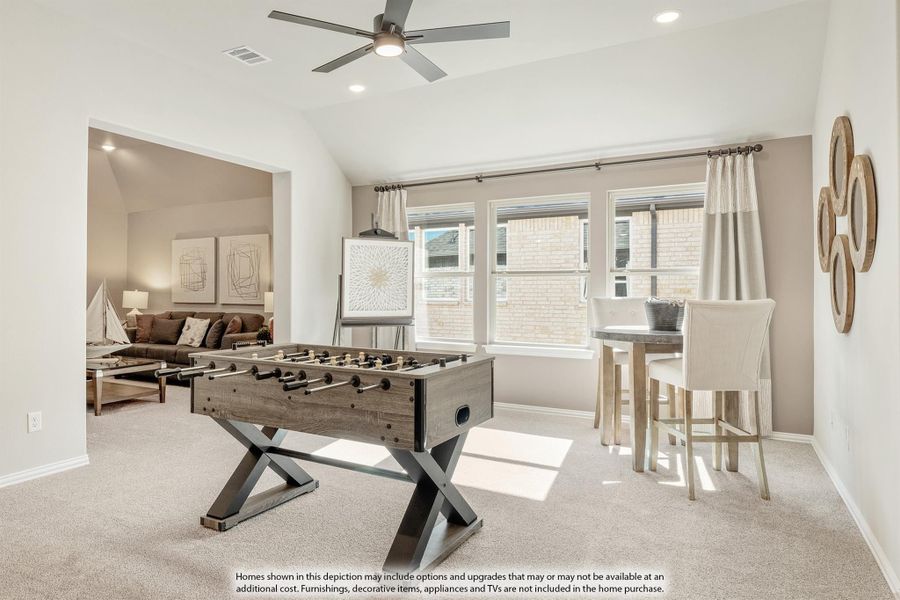 Game room with foosball table, ceiling fan, carpet floors, and open view to living area Game room with foosball table, ceiling fan, carpet floors, and open view to living area