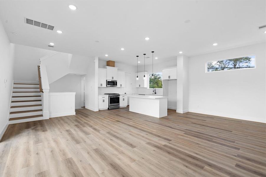 A clean white staircase with mordern railing is located to the side