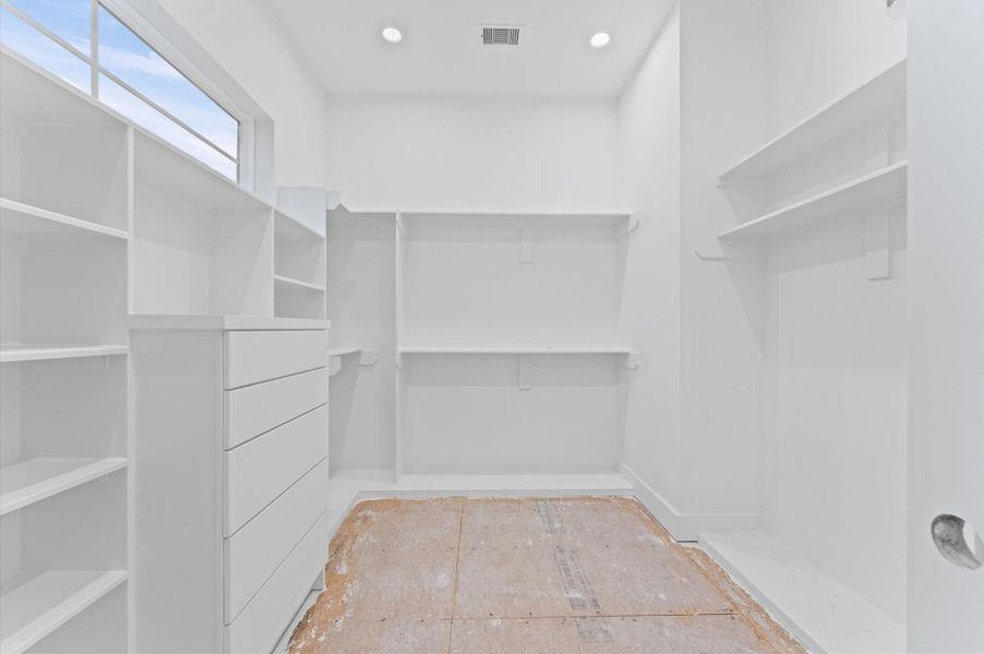 Primary closet includes a built in chest of drawers. Primary closet includes a built in chest of drawers.