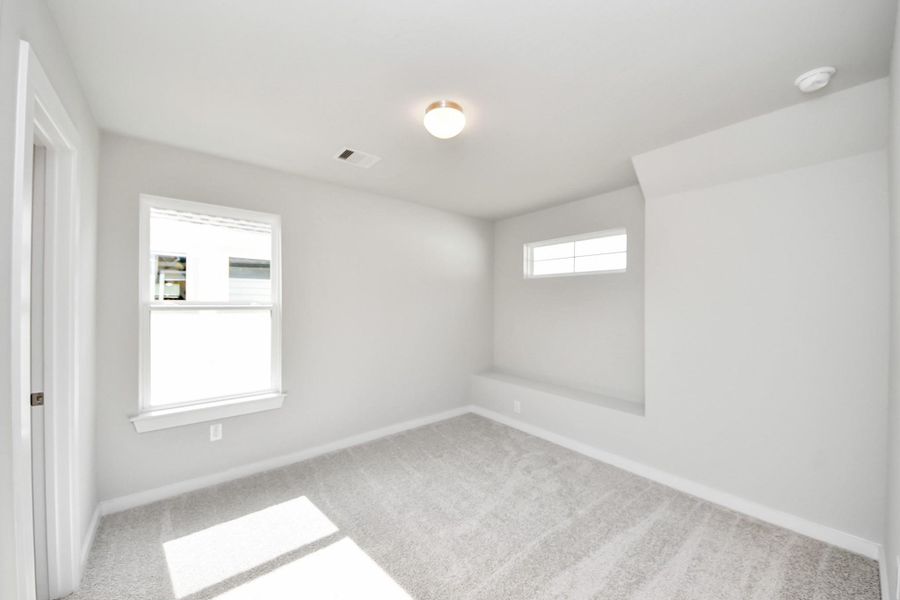 Secondary bedroom features plush carpeting, large windows that let in plenty of natural light, bright paint, and spacious closets. Secondary bedroom features plush carpeting, large windows that let in plenty of natural light, bright paint, and spacious closets.