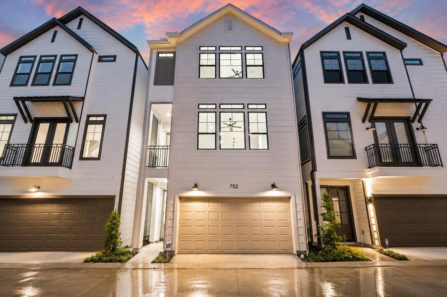 Sophisticated front elevation with warm lighting and modern farmhouse design Sophisticated front elevation with warm lighting and modern farmhouse design