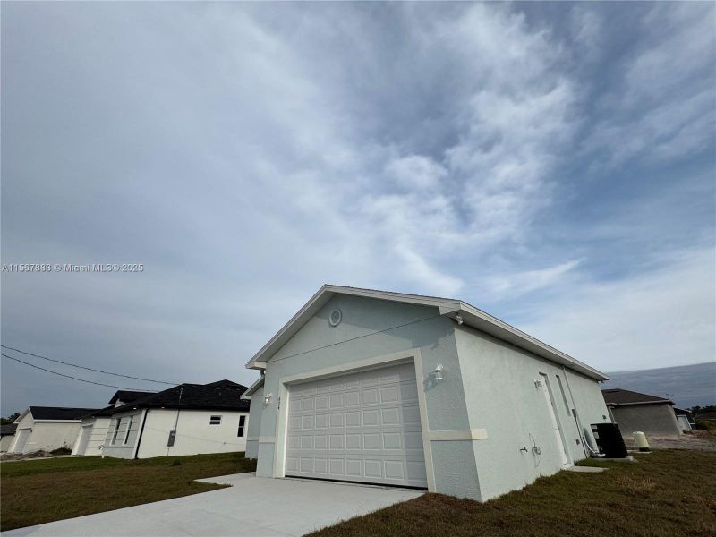 Front exterior of a new home in , Lehigh Acres, FL, highlighting curb appeal (Image 15).
