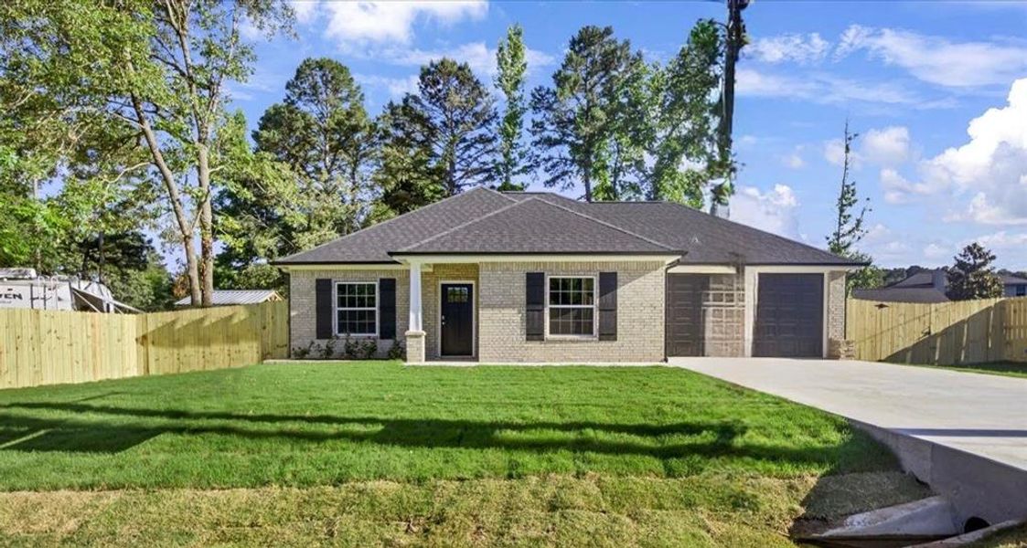 View of front of house featuring driveway, an attached garage, brick siding, and roof with shingles