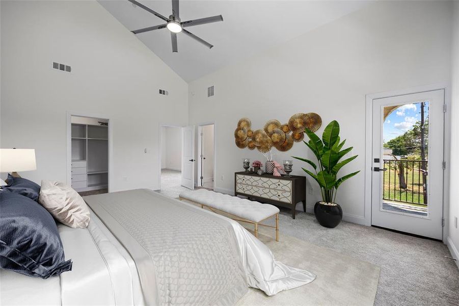 Carpeted bedroom featuring a closet, access to outside, high vaulted ceiling, a spacious closet, and ceiling fan