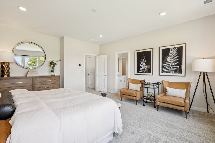 A bedroom with a bed and a chair. A bedroom with a bed and a chair.